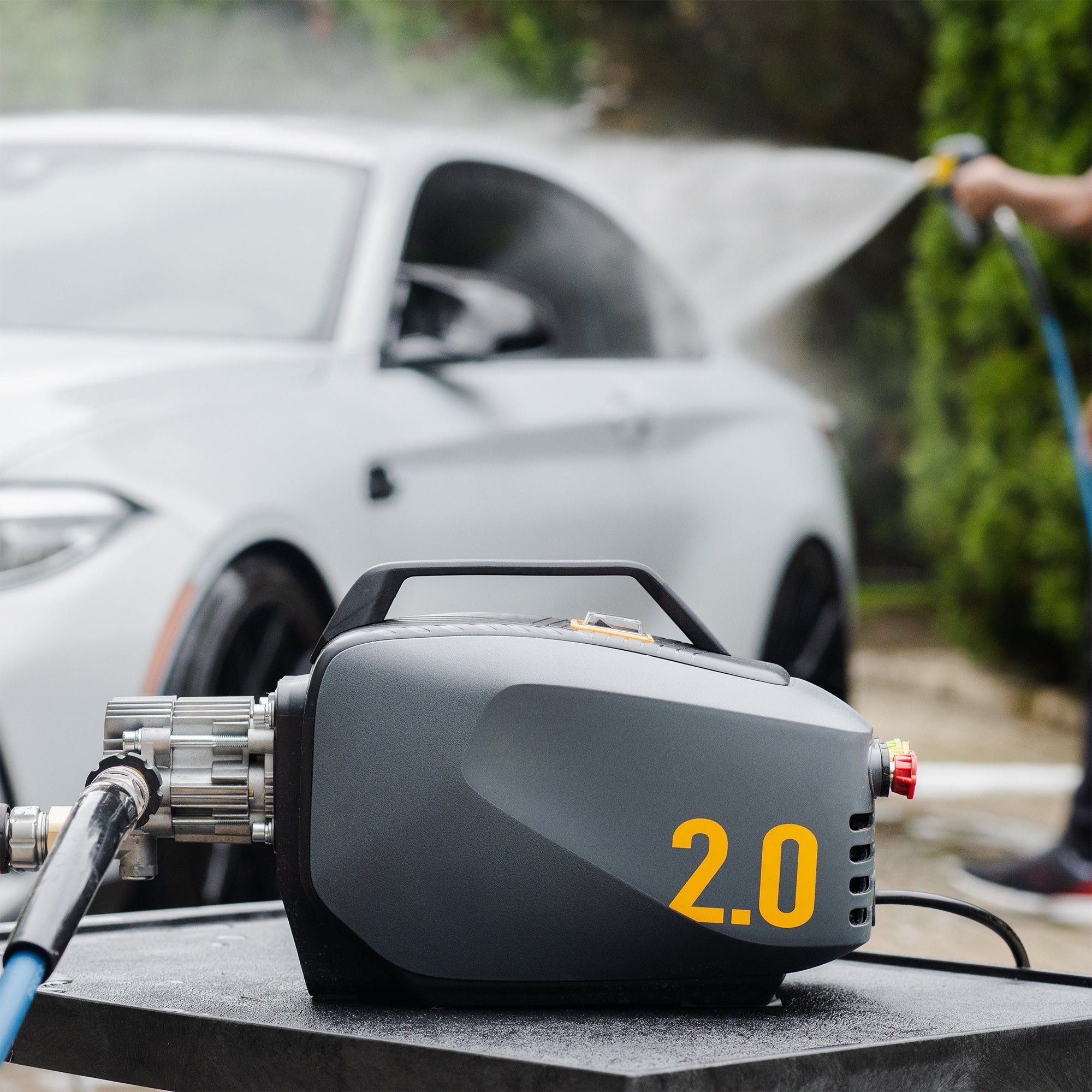 Side angle view of active 2.0 electric pressure washer in a casr wash background